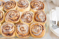 there are many cinnamon rolls on the table