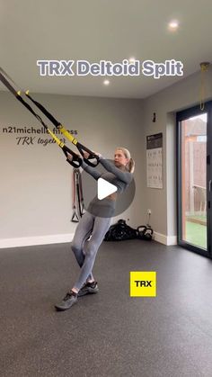 a man is doing aerial exercises in the gym while holding on to an exercise rope