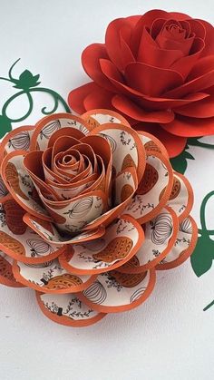 two paper flowers sitting on top of each other