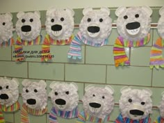 there are many polar bears made out of paper plates on the wall in this classroom