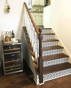 there is a wine rack on the stairs next to the counter top and below it