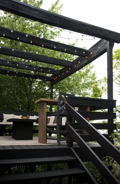 a wooden deck with lights strung over it