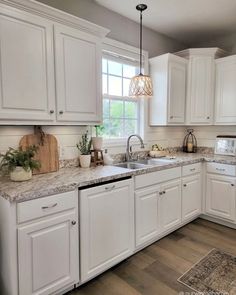 the kitchen is clean and ready for us to use it's white cabinetry