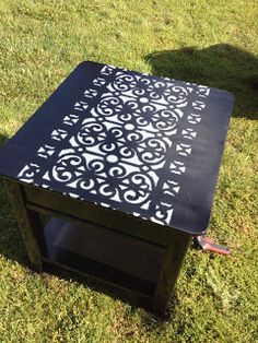 a black and white table sitting in the grass