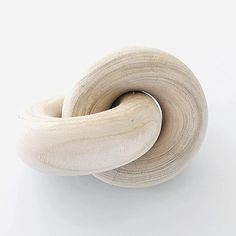 two pieces of wood sitting next to each other on a white surface with no one around them