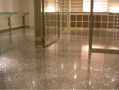 an empty room with shiny floors and glass doors