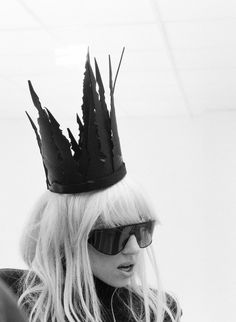 a woman with sunglasses and a crown on her head