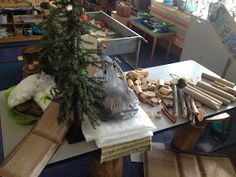 there is a christmas tree in the middle of this workbench with many pieces of wood on it