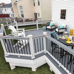 an outdoor deck with chairs and table on it