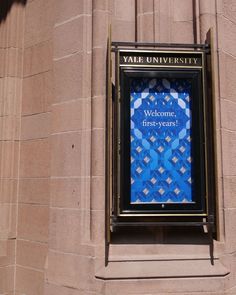 a welcome sign on the side of a building