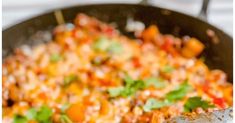 a skillet filled with lots of food on top of a stove