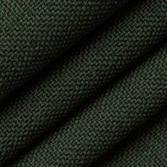 dark green fabric textured with small dots on the top and bottom, as well as an