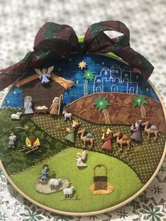 a cross stitch ornament with nativity scene on it