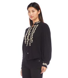 Expertly crafted for style and comfort, this embroidered shirt showcases hand-crocheted details on a soft rayon gauze fabric. Enjoy the delicate touch of intricate design while indulging in the luxury of lightweight material. Perfect for any occasion. True to size Rayon Gauze: 100% Rayon Imported Dry Clean Or Hand Wash Cold Water. Lay Flat To Dry. Length: 25 1/8 inches (size M) Sleeves with cuffs Mandarin collared Hand crochet detail Button front (buttons are covered with embroidered thread) | K Karen Kane, Gauze Fabric, Crochet Details, Intricate Design, Embroidered Shirt, Mandarin Collar, Hand Crochet, Lay Flat, Cold Water