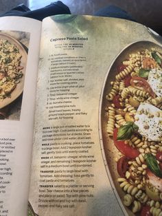 an open cookbook showing pasta salad with tomatoes and mozzarella on the side