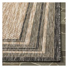 an area rug with different colors and patterns on the floor, including black, brown, beige