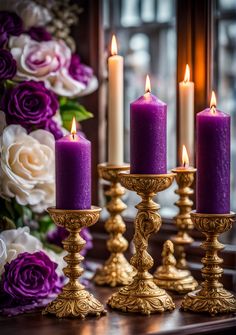 purple candles are lined up on a table