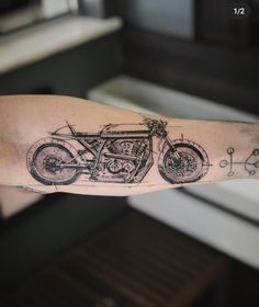 a man's arm with a motorcycle tattoo on it