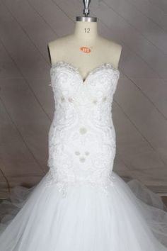 a white wedding dress on a mannequin