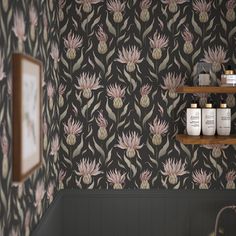 a bathroom with wallpaper and shelves filled with jars on the wall next to it