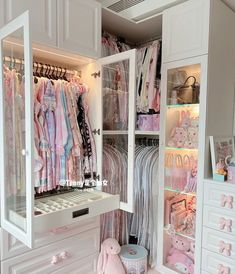 a white closet filled with lots of baby clothes