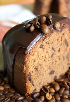 a piece of cake with chocolate frosting and coffee beans