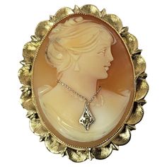 Vintage 14 Karat Yellow Gold and Diamond Cameo Brooch/Pendant- This elegant brooch features a lovely lady in profile set beautifully detailed 14K gold. Can be worn as a brooch or a pendant. Accented with one round single cut diamond. Approximate total diamond weight: .02 ct. Diamond clarity: M Diamond color: SI1 Size: 36 mm x 30 mm Weight: 5.1 dwt. / 8.0 gr. Stamped: 14K ESEMO Very good condition, professionally polished. Will come packaged in a gift box or pouch (when possible) and will be shipped U.S. Priority Mail Insured. DV092622/17KCS Fine Gold Jewelry, Cameo Jewelry, Carved Shell, Gold Diamond Necklace, Cameo Brooch, Valentines Day Gifts For Her, Pin Pendant, Pin Brooch, Colored Diamonds