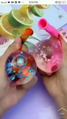 someone is holding two plastic toys in their hands and they are making soap bubbles with them