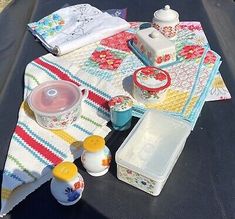 the picnic table is set up with dishes and utensils