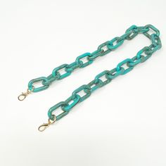 Your handbag game is about to step up a notch! Mix and match any one of our bag straps with your favorite party box or bring new life to the bags you already own and love. All bags and straps sold separately so you can customize. Features an oval chain strap in turquoise with gold toned oversized lobster clasp. ▪️Length: 25.5", Width: 1"▪️Materials: acrylic, plated metals. Accessories curated for Closet Rehab. Trendy Green Bag Strap For Everyday, Trendy Green Everyday Bag Strap, Green Adjustable Rectangular Bag Strap, Trendy Handmade Rectangular Bag Strap, Handmade Rectangular Trendy Bag Strap, Adjustable Rectangular Bag Strap, Trendy Blue Bag Strap For Everyday, Blue Rectangular Adjustable Bag Strap, Acrylic Purse