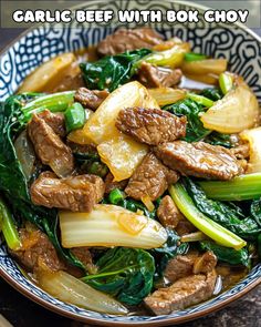 a bowl filled with beef and vegetables on top of a table