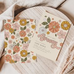 two cards with flowers on them sitting next to each other