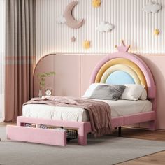 a bedroom with pink walls and white bedding has a rainbow shaped headboard on it