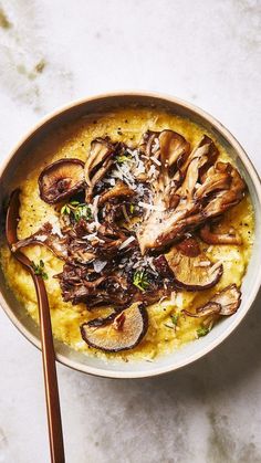 a bowl of food with mushrooms and parmesan cheese