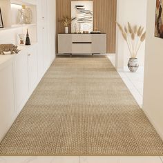 a beige rug in the middle of a room with white walls and shelves on either side