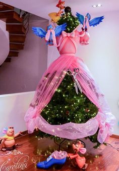 there is a christmas tree that has been decorated with pink and blue fairy dusters