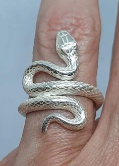 This is a solid sterling silver snake that entwines itself around your finger. It is a beautifully detailed 3 dimensional snake. You can wear it either headed toward you or away from you. While the ring pictured is sterling silver, we also make this ring in 10, 14, and 18k gold, as well as platinum. Just see the drop down menu for pricing. FREE domestic First Class shipping!! If you need faster shipping, please choose Priority Mail or Express Mail from the drop-down list. While puzzle rings are Sterling Silver Snake-shaped Rings, Unique Sterling Silver Snake Ring, Silver Sterling Snake-shaped Ring, Sterling Silver Snake Ring Gift, Sterling Silver Snake Ring, Puzzle Rings, Puzzle Ring, Serpent Ring, Snake Ring