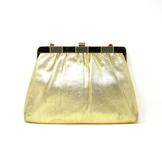 "Vintage gold purse. Lamé evening bag. 1960s Harry Levine clutch with optional metallic snake chain handle, that can be tucked inside. Marked HL USA. A mid century evening handbag. Approximate size: 9\" x 6 ¼\" x 7/8\" thick when closed Opening approximately 4 ½\" x 4\" when opened Marked on the interior: \"HL U.S.A.\" Condition: Very good, vintage, used condition. There is a touch of wear to the lamé fabric at the bottom corners and a few very minor and small blemishes to the sheen throughout t Vintage Gold Shoulder Bag With Gold-tone Hardware, Classic Gold Shoulder Bag For Evening, Vintage Gold Shoulder Bag, Vintage Gold Shoulder Bag For Party, Classic Gold Clutch Bag, Vintage Gold Shoulder Bag For Formal Occasions, Gold Bag With Gold Clasp For Everyday Use, Gold Bags With Gold Clasp For Everyday Use, Gold Everyday Bag With Gold Clasp