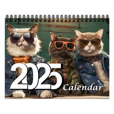 a calendar with three cats wearing sunglasses and one cat in a jacket, sitting on a bench