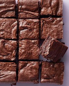 chocolate brownies cut into squares on a white surface