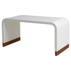 a white table with brown trim on the top and bottom edge, against a white background