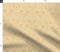 a yellow and white wallpaper with small leaves on it, as well as a ruler