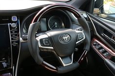 the interior of a car with steering wheel and dashboard