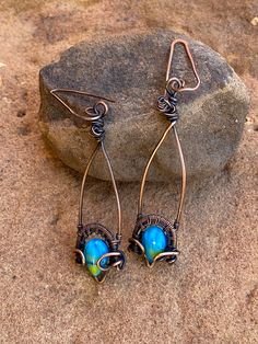 "Pretty wrapped drop earrings are made of copper. Small glass cabochons are a beautiful sea blue and sun yellow. Earrings are approximately 2 3/8\" from top of wire. Light weight. If you are like me and are allergic to copper wires, I will gladly exchange them for sterling at no charge. Free shipping to USA" Blue Copper Wire Wrapped Earrings, Blue Wire Wrapped Copper Earrings, Blue Copper Wire Earrings With Ear Wire, Beach Colors, Copper And Pink, Earrings Beach, Sun Yellow, Glass Drop Earrings, Beach Color