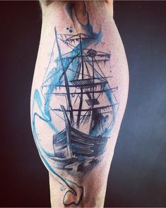 a man's leg with a ship tattoo on it