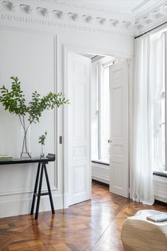 an empty room with white walls and wooden floors