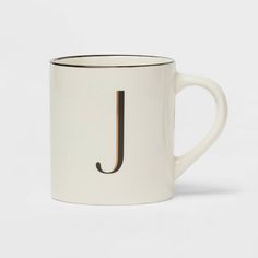 a white coffee mug with the letter j on it