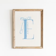 the letter e is drawn in blue ink on a white paper with a wooden frame