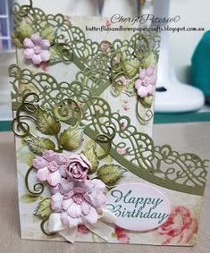 a close up of a greeting card with flowers and leaves on the inside of it