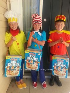 three children in costumes holding boxes of rice krispy kreme cereal outside the door